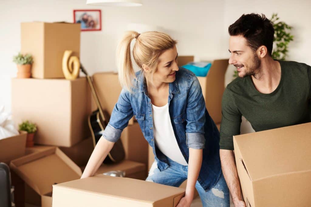 couple unpacking stuff from cartons